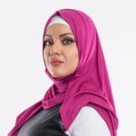 Woman wearing a vibrant fuchsia premium jersey hijab styled with a front drape, demonstrating the soft and opaque fabric.