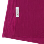 Neatly folded fuchsia premium jersey hijab on a flat surface, showcasing its rich pink color and medium-weight fabric.