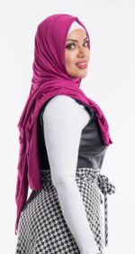 Side profile of a woman wearing the fuchsia premium jersey hijab, highlighting the comfortable, pin-free stretch fit.