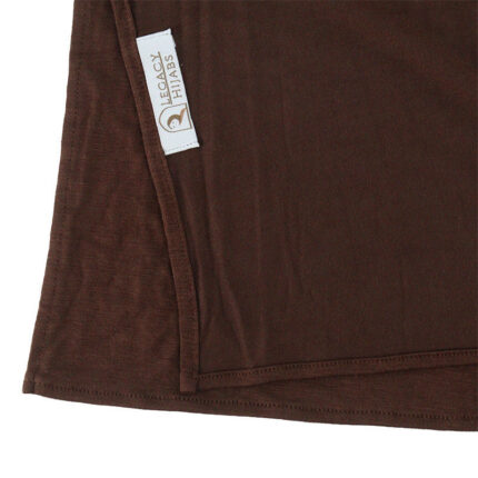 Neatly folded cocoa brown premium jersey hijab showcasing its rich brown color, smooth stretch fabric, and the Legacy Hijabs brand tag.