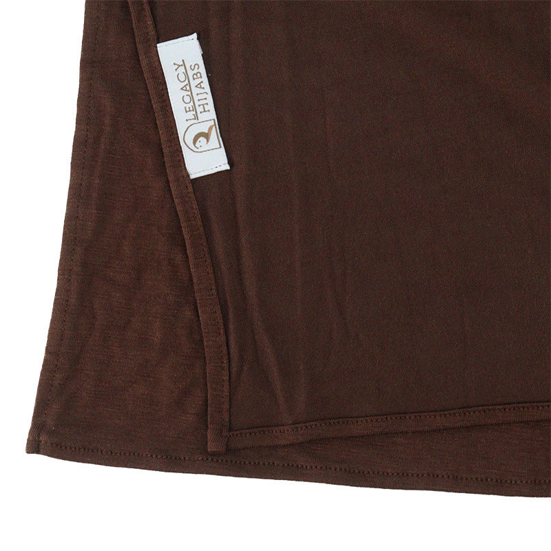Neatly folded cocoa brown premium jersey hijab showcasing its rich brown color, smooth stretch fabric, and the Legacy Hijabs brand tag.
