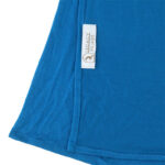 Neatly folded aqua blue premium jersey hijab on a flat surface, displaying its soft blue color and medium-weight fabric.