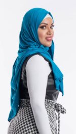 Side profile of a woman wearing the aqua blue premium jersey hijab, showcasing the comfortable, pin-free stretch fit.