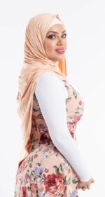 Side profile of a woman wearing the camel premium jersey hijab, showcasing the comfortable, pin-free stretch fit.