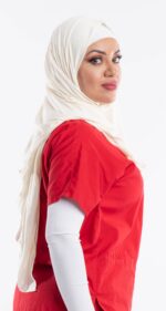 Side profile of a woman wearing the cream white premium jersey hijab, highlighting the comfortable, pin-free stretch fit.