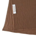 Neatly folded dark mocha premium jersey hijab on a flat surface, showcasing its rich coffee-brown tone and medium-weight fabric.