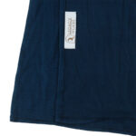 Neatly folded dark teal premium jersey hijab on a flat surface, showcasing its rich, cool-toned blue-green color and medium-weight fabric.