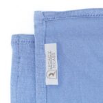 Neatly folded denim blue premium jersey hijab on a flat surface, showcasing its muted blue tone and medium-weight fabric.