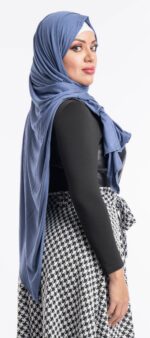 Side profile of a woman wearing the denim blue premium jersey hijab, highlighting the comfortable, pin-free stretch fit.