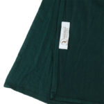 Neatly folded forrest green premium jersey hijab on a flat surface, showcasing its rich, dark green tone and medium-weight fabric.