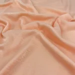 Apricot velvet satin hijab with a soft, light-catching sheen