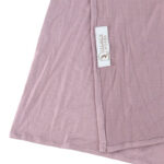 Neatly folded lavender premium jersey hijab on a flat surface, showcasing its gentle pastel purple tone and medium-weight fabric.