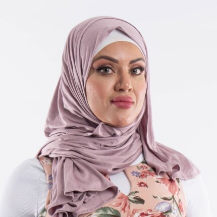 Woman wearing a soft lavender premium jersey hijab styled with a front drape, demonstrating the smooth and opaque fabric.
