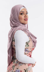 Side profile of a woman wearing the lavender premium jersey hijab, highlighting the comfortable, pin-free stretch fit.