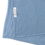 Neatly folded light blue premium jersey hijab on a flat surface, showcasing its gentle pale blue tone and medium-weight fabric.