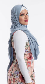 Side profile of a woman wearing the light blue premium jersey hijab, highlighting the comfortable, pin-free stretch fit.