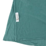 Neatly folded mint green premium jersey hijab on a flat surface, showcasing its refreshing pale green tone and medium-weight fabric.