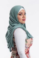Side profile of a woman wearing the mint green premium jersey hijab, highlighting the comfortable, pin-free stretch fit.