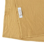 Neatly folded mustard yellow premium jersey hijab on a flat surface, showcasing its rich golden-yellow tone and medium-weight fabric.