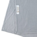 Neatly folded mystic grey premium jersey hijab on a flat surface, showcasing its versatile cool grey tone and medium-weight fabric.