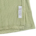 Neatly folded olive green premium jersey hijab on a flat surface, showcasing its deep earthy green tone and medium-weight fabric.