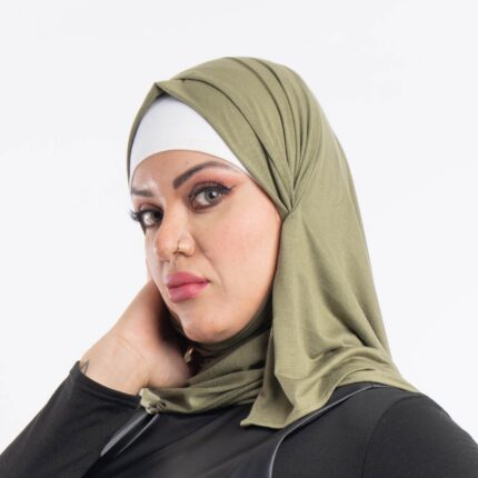 Woman wearing a rich olive green premium jersey hijab styled with an elegant front drape, demonstrating the smooth and opaque fabric.