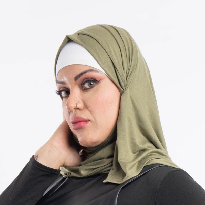 Woman wearing a rich olive green premium jersey hijab styled with an elegant front drape, demonstrating the smooth and opaque fabric.