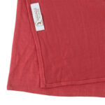 Neatly folded watermelon premium jersey hijab on a flat surface, showcasing its bright pinkish-red tone and medium-weight fabric.